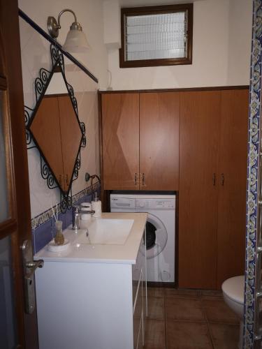 a bathroom with a sink and a washing machine at Casa Arena Negra Edificio A'costa in Puerto Naos