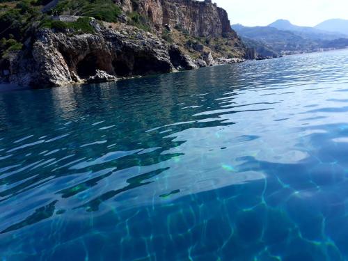 a body of water next to a rocky cliff at B&B Mediterraneo in Cetraro