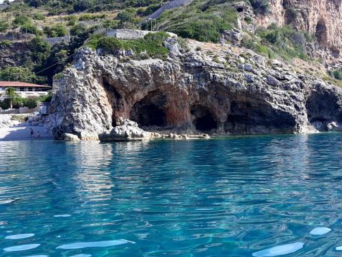 a cave in a rocky cliff next to the water at B&B Mediterraneo in Cetraro