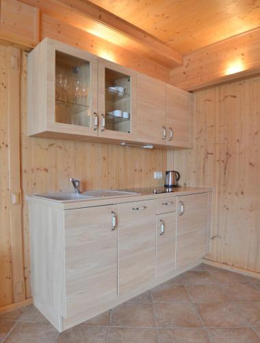 a kitchen with wooden cabinets and a counter top at Gästehaus Wildgehege in Wilhelm