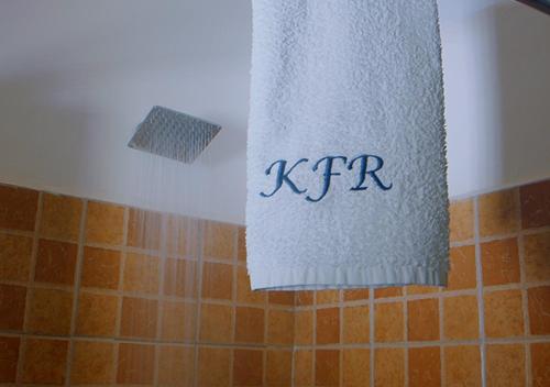 a towel that is hanging in a bathroom at Kampala Forest Resort - KFR Lodge in Kampala