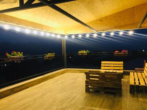 a room with two chairs and lights on a balcony at Bucha`s Guest House & Wine Cellar in Tʼelavi