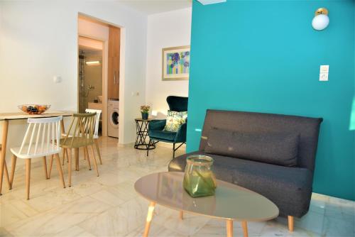 ein Wohnzimmer mit einem Sofa und einem Tisch in der Unterkunft Emerald Apartment Halepa in Chania