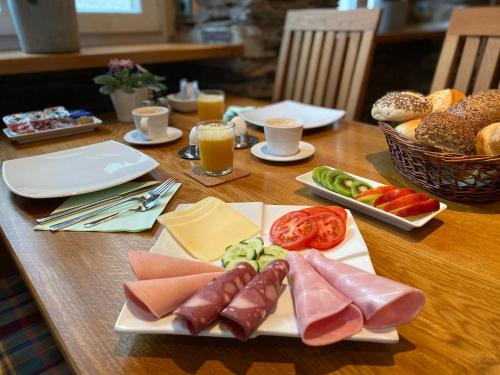 uma mesa de madeira com pratos de comida e bebidas em MOSELTEL Ernst,Cochem em Ernst