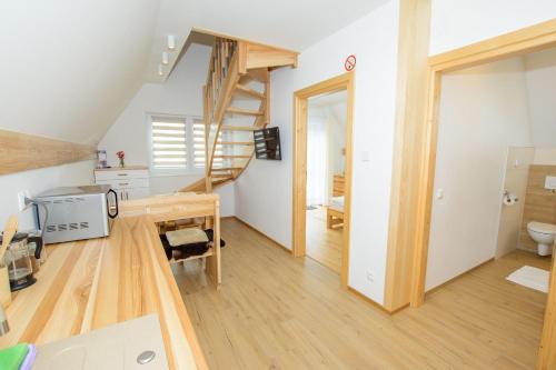 a small room with a staircase and a kitchen at Apartamenty Toporowe Domki in Witów