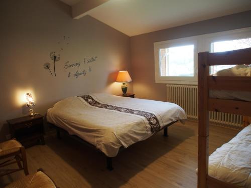 a bedroom with two beds and a window at Escale en Revermont in Saint-Lothain