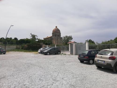 a parking lot with cars parked in front of a building at Residenza Azzurra in Tropea