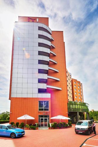 ソフィアにあるMetropolitan Hotel Sofia, a member of Radisson Individualsの前に車が駐車されている大きな建物