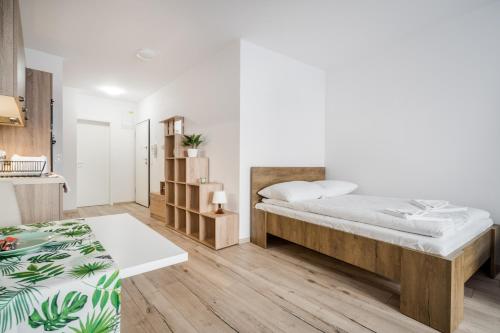 um quarto branco com uma cama e uma cozinha em BpR Brody Street Home em Budapeste