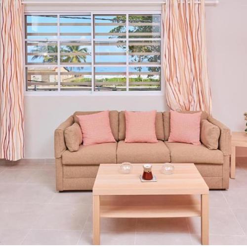 a living room with a couch and a coffee table at Apartahotel MACADANA in Nagua