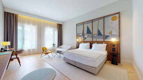 a hotel room with a bed and a table and chairs at Dukley Hotel & Resort in Budva
