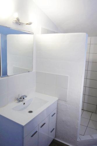 a white bathroom with a sink and a mirror at Olive Branch El Chorro in El Chorro