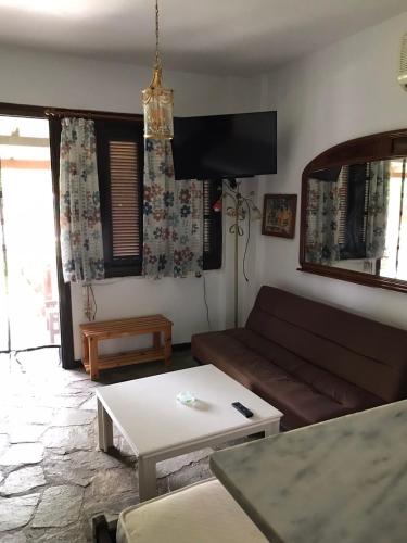 a living room with a couch and a table at Oasis in Skiathos