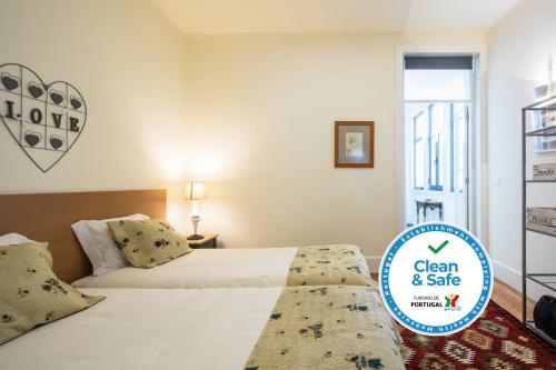 a bedroom with a bed and a sign that says clean and safe at À Francos Artist Painting in Porto