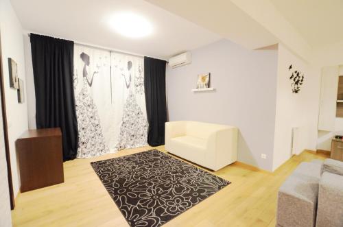 a living room with a couch and a rug at Upground Residence Apartments in Bucharest
