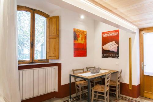 - une salle à manger avec une table et des chaises dans l'établissement Loft viaveneto, à Volterra
