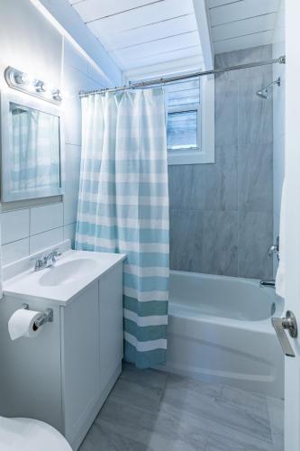 a white bathroom with a sink and a shower at Boutique Suite #7 in Blue Mountains