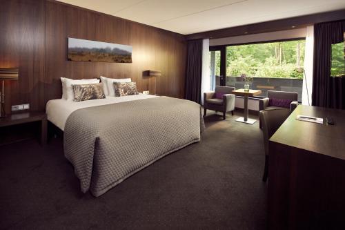 a hotel room with a bed and a large window at Van der Valk Hotel Arnhem in Arnhem
