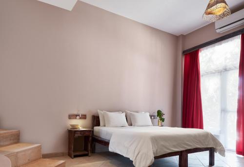 a bedroom with a bed with a red curtain at All Blue in Jericoacoara