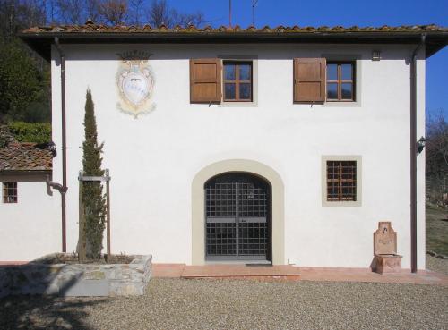 a white building with a door and a window at Casignano in Bagno a Ripoli