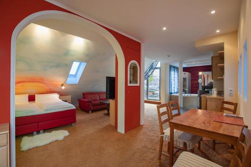 a bedroom with a bed and a table and a dining room at Bavaria Lifestyle Hotel mit Klimaanlage in Altötting