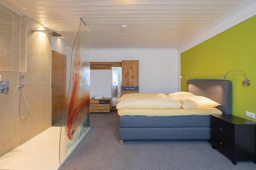 a bedroom with a bed and a shower at Altötting City Apartments in Altötting