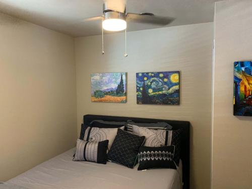 a bedroom with a bed with paintings on the wall at Dillon Ave Homes in Cheyenne