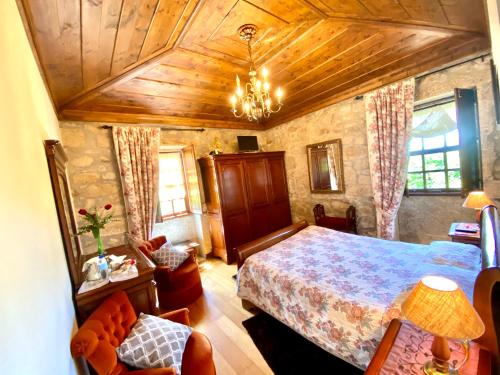 a bedroom with a bed and a wooden ceiling at Casa do Outeirinho- Turismo Rural in Penedo