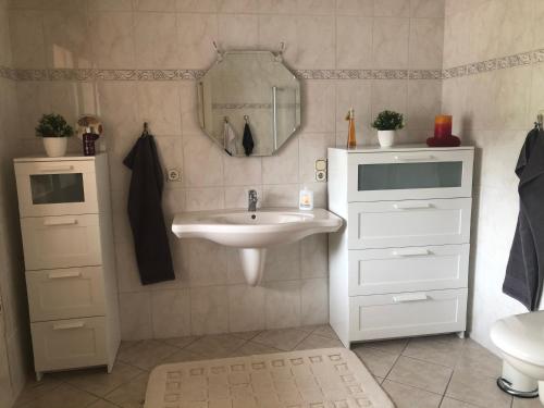 a bathroom with a sink and a mirror at Ferienhaus in Sankt Aldegund
