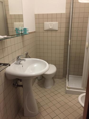 a bathroom with a sink and a toilet at Asselta Hotel in Cerignola