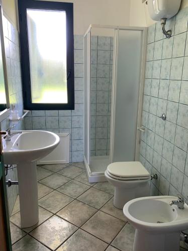 a bathroom with a sink and a toilet and a shower at Hotel La Ciaccia in Valledoria