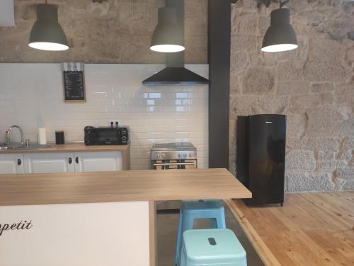 a kitchen with a stove top oven and a microwave at Hospédate Pontevedra in Pontevedra