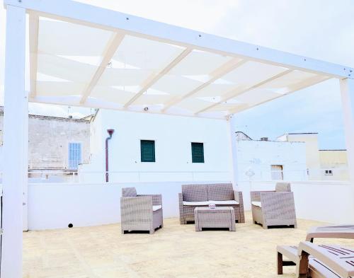 a large white room with chairs and a table at Casa Camilla in Monopoli