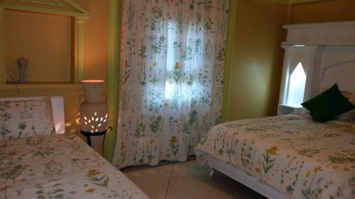 a bedroom with two beds and a window at Tigmi Dar Samy in Bine el Ouidane