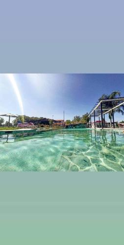 a rainbow in the sky over a swimming pool at Lusitaurus in Montoito