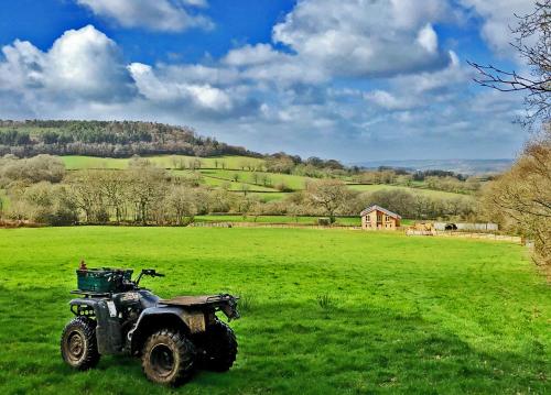 a quad bike parked in a field in a field at Blackdown Views - New 6 Bedroom Eco House in Dunkeswell