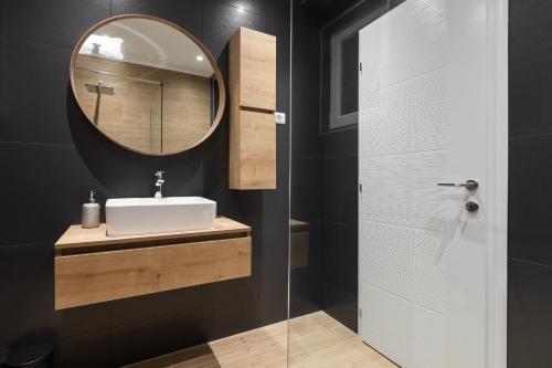a bathroom with a sink and a mirror at IvMaLu Apartments in Tučepi