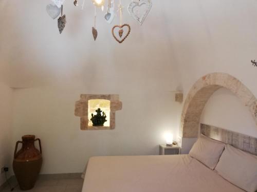 a bedroom with a bed and a window with butterflies on the wall at Marinelli Guest House in Cisternino