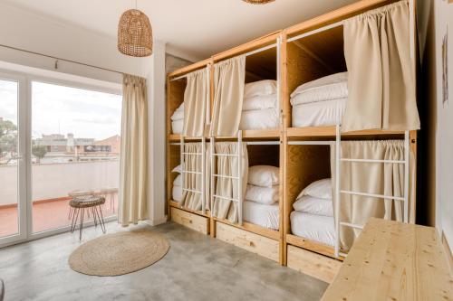 a room filled with lots of shelves filled with towels at Selina Boavista Ericeira in Ericeira