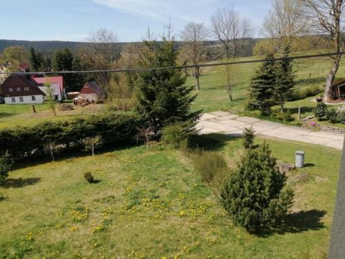 a view of a field with trees and a house at U Petíse in Horní Blatná