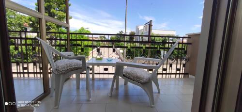 a balcony with a table and chairs on a balcony at GIOIArooms in Trani