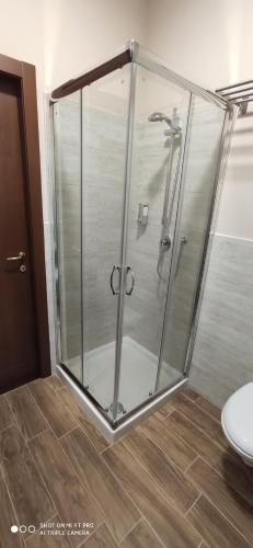 a shower with a glass enclosure in a bathroom at GIOIArooms in Trani
