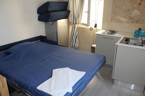 a hospital room with a blue bed and a sink at Sansego Suites in Susak
