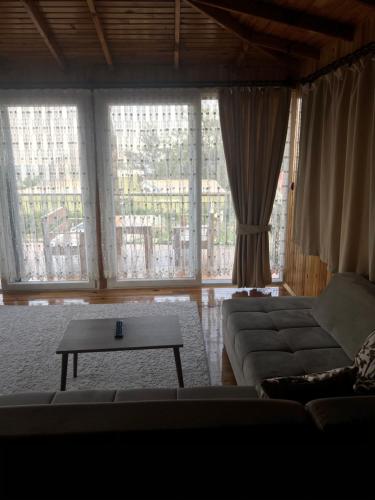 a living room with a couch and a table at yenivadi in Antalya