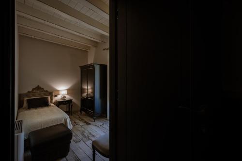 a bedroom with a bed and a table with a lamp at Donna Carolina Luxury rooms in Cefalù