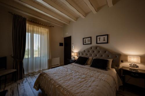 a bedroom with a large bed and a large window at Donna Carolina Luxury rooms in Cefalù
