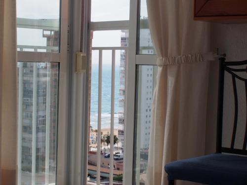a room with a window with a view of the ocean at virginia-48 in Benidorm