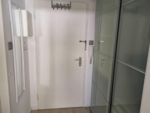 una porta bianca in una stanza con una parete di vetro di City-Apartment Perle a Bremerhaven