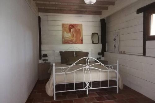 1 dormitorio con 1 cama blanca en una habitación en gite Pedelucq, en Pouillon