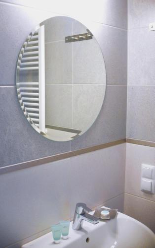 a bathroom with a mirror and a sink at Stara Cynkownia in Czechowice-Dziedzice